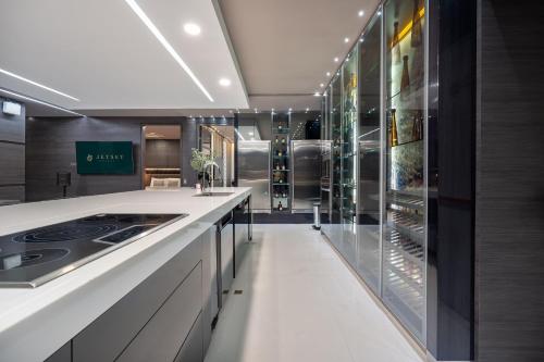 a large kitchen with a counter and a refrigerator at Europa Suites Medellin in Medellín