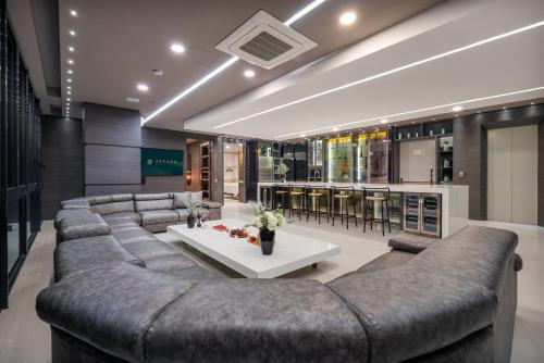 a living room with a large couch and a table at Europa Suites Medellin in Medellín