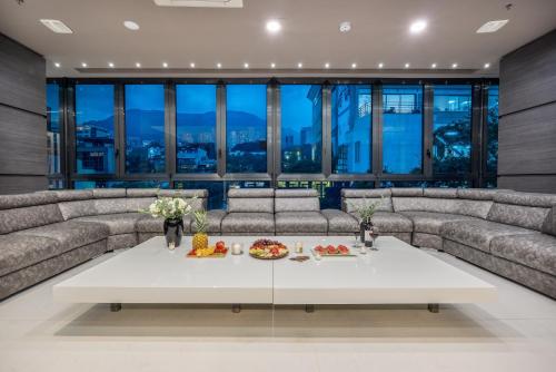 a living room with couches and a table with food on it at Europa Suites Medellin in Medellín