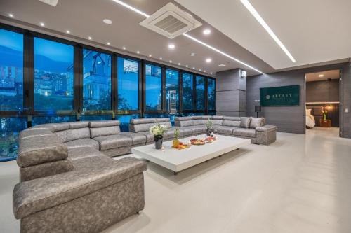 a living room with couches and a table at Europa Suites Medellin in Medellín