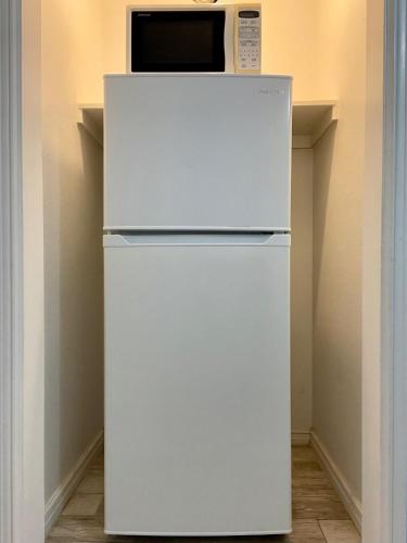 a white refrigerator with a microwave on top of it at Beachgate Condo Suites and Hotel 512AB condo in Port Aransas
