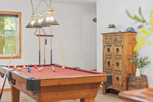 a pool table with balls on it in a room at Tawny and Peaceful Game Room Firepit PatioDeck Workspace in Arrowhead Lake