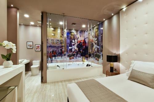 a bedroom with a large shower and a bed and a tub at Europa Suites Medellin in Medellín