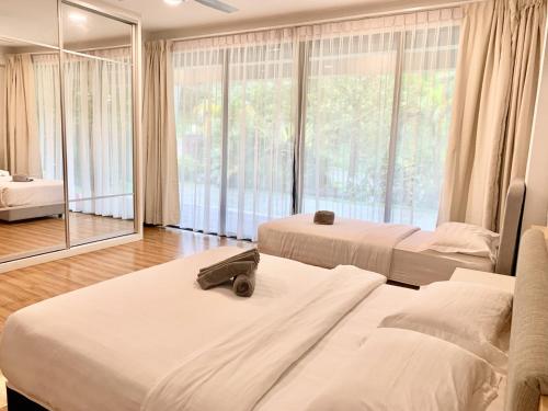 a bedroom with two beds and a large window at Deco Home Mesilau Golf Bungalow Kundasang in Kundasang