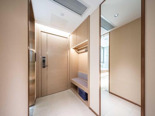 a walk in closet with a large mirror at Lavande Hotel Dongguan Dongkeng in Dongguan