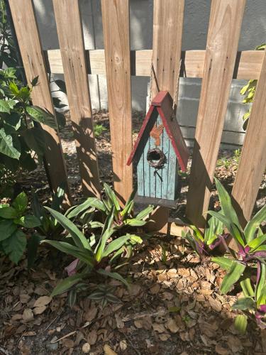 a bird house sitting on the side of a fence at Serenity Gardens private guest suite in Historic Lutz in Lutz