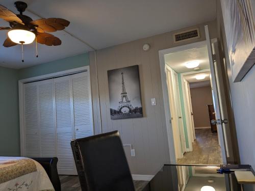 a bedroom with a glass table and a view of the eiffel tower at Ocean Front by Cocoa Beach Pier in Cocoa Beach