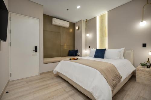 a large bedroom with a large bed with a window at Europa Suites Medellin in Medellín