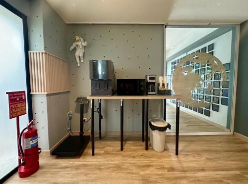 a room with a table with a astronaut on the wall at Bed-room at Suvarnabhumi Airport - Newly renovated in Lat Krabang