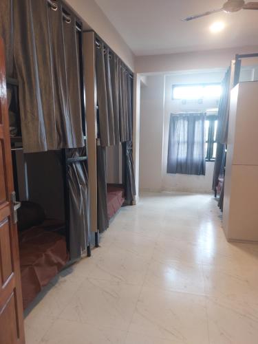 a hallway of a room with curtains and a floor at Cheklaa-a Backpacker's Hostel in Imphal