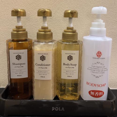 a tray with four bottles of essential oils on it at Hotel Mio Plaza (Adult Only) in Yokkaichi