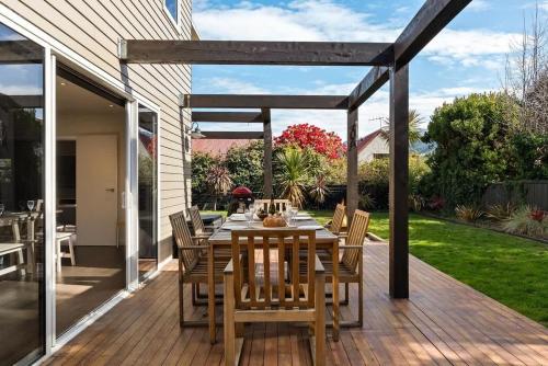 a wooden deck with a table and chairs at Whakata on McBride in Queenstown
