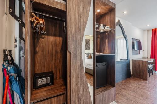 a room with a wooden door with a mirror at C202 Sun and Fun Kids Club 1BR 500m to Beach in Kata Beach