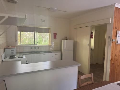 a kitchen with a white refrigerator and a window at Ovensview On Riverside in Bright