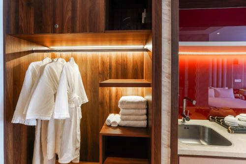 a bathroom with a sink and a towel rack at Mandala Pearl Azure Retreat in Ấp Nhơn Long