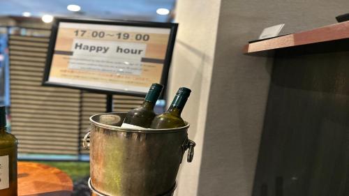 two bottles of wine in a bucket on a counter at Kanazawa New Grand Hotel Prestige in Kanazawa