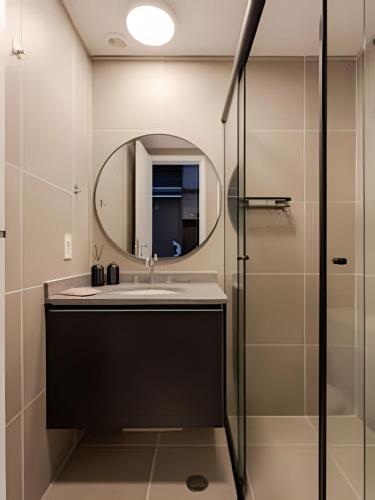 a bathroom with a sink and a mirror at Nik Perdizes in Sao Paulo