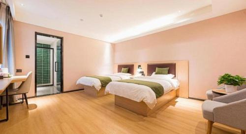 a large bedroom with two beds and a desk at GreenTree Inn Express Chuzhou Langya District Government Chuhe Road in Chuzhou