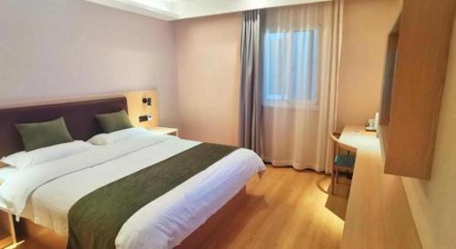 a hotel room with a large bed and a window at GreenTree Inn Express Chuzhou Langya District Government Chuhe Road in Chuzhou
