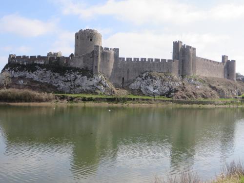 a castle on an island in a body of water at Tregenna Licenced Bed & Breakfast in Pembroke