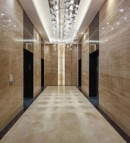 a hallway of a building with a chandelier at 1BR Chadstone With Pool and Gym in Kedungg