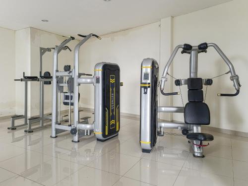 a row of exercise equipment in a gym at 1BR Chadstone With Pool and Gym in Kedungg