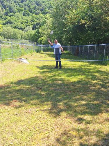 a man standing in a field holding a frisbee at Igloo Rasnov in Râşnov