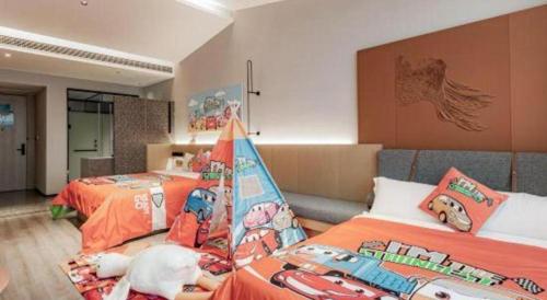 a bedroom with two beds and a couch at Airfeel Hotel in Ziyang
