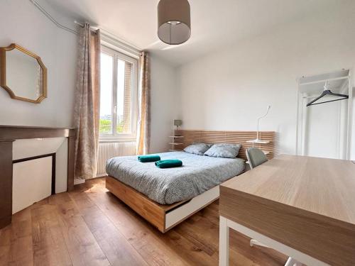 une chambre avec un lit et une table dedans dans l'établissement Appart 6 pers - Pradelle 2, à Clermont-Ferrand