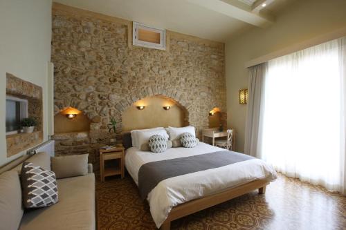 a bedroom with a large bed and a couch at Dar Alma in Soûr