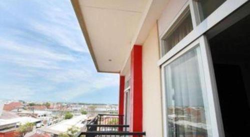 a balcony of a building with a view of a city at Karlita Hotel Tegal in Tegal