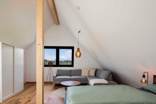 a living room with a couch and a bed at Hinterland&See in Tettnang