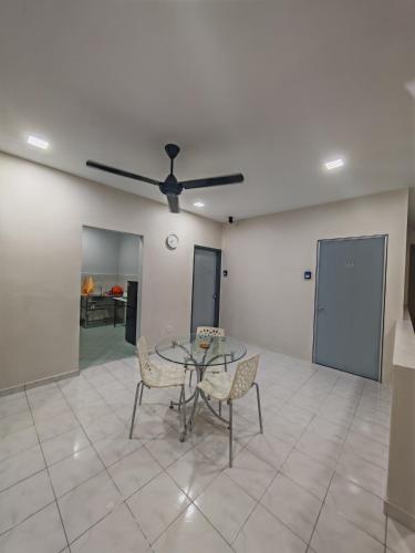 a dining room with a table and chairs and a ceiling fan at MixxHome Seremban 2, One Queen Bed, Private Bathroom in Seremban