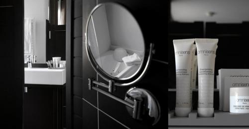 a mirror on a bathroom wall next to a sink at L auberge de la pointe in Soustons