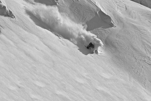a person is skiing down a snow covered slope at Apartments Kvasničník in Demanovska Dolina