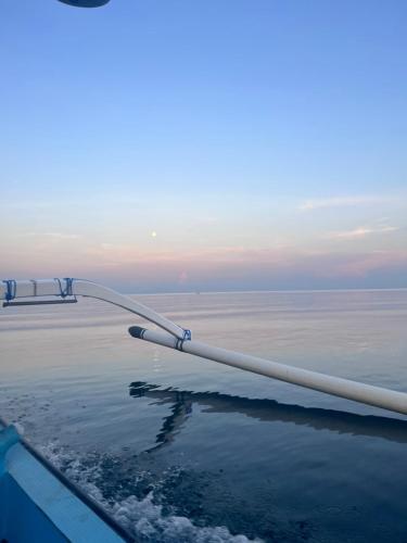 a view of the wing of a plane flying over the ocean at Beachfront Villa Jepun Segara in Banjar