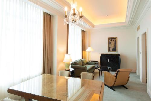a living room with a dining table and chairs at Hotel The Manhattan in Chiba