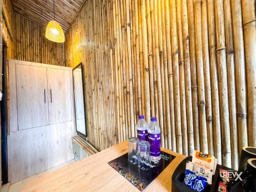 a room with a wooden wall with bottles on a table at Euphoric Tiger Resort in Rishīkesh