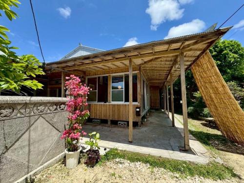 a small house with a wooden roof at -大人数で泊まれる一棟貸し-なかまあじーんやー海近くの素敵な島暮らし体験-手久津久- in Kikaiga Shima