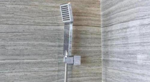 a shower head with water coming out of it at Chambery Hotel in Zhuhai