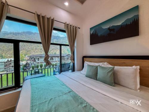 a bedroom with a bed with a large window at Euphoric Tiger Resort in Rishīkesh