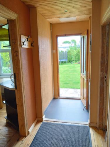 a hallway with a door leading to a yard at Viktorijas dārzs in Liepāja