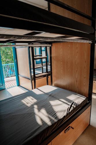 a bunk bed with the shadow of a person on it at Quiri Hostel in Hanoi