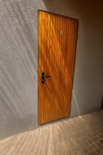 a wooden door in the corner of a room at Helena guest house in Cholpon-Ata