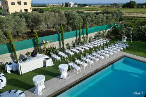 an outdoor wedding with a table and chairs next to a pool at Kiti Village Villa, Cyprus, salt-water pool, 5 bedrooms, Larnaca in Kiti