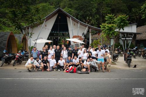 a group of people posing for a picture on the street at Quiri Hostel in Hanoi
