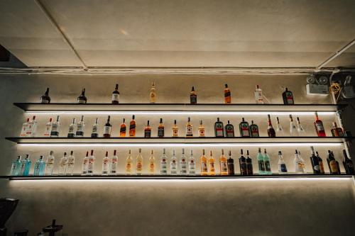 a row of shelves with different types of alcohol at Quiri Hostel in Hanoi