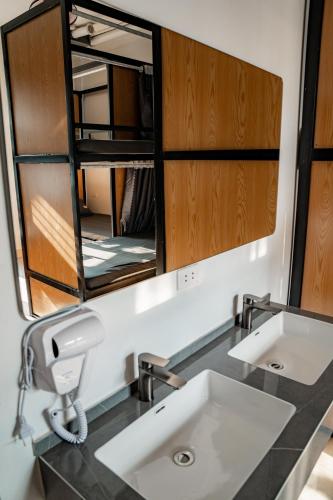 a bathroom with a sink and a mirror at Quiri Hostel in Hanoi