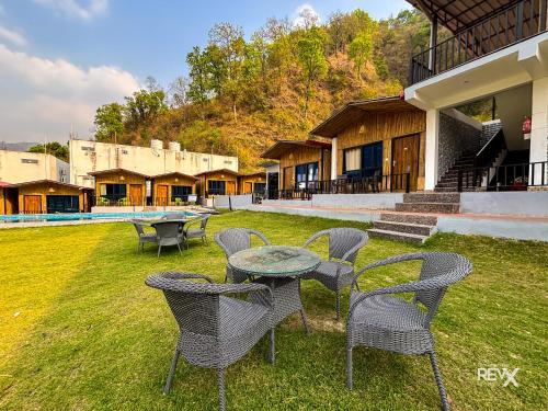 a group of chairs and a table in a yard at Euphoric Tiger Resort in Rishīkesh