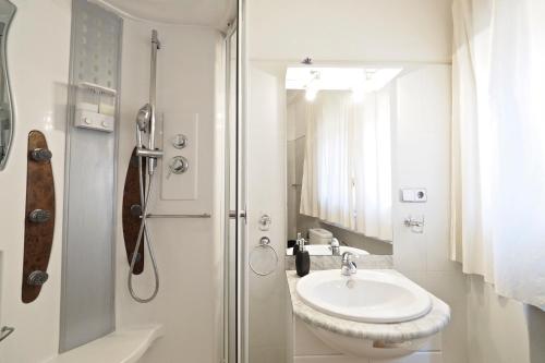 a white bathroom with a sink and a shower at Monrooms Barcelona in Barcelona